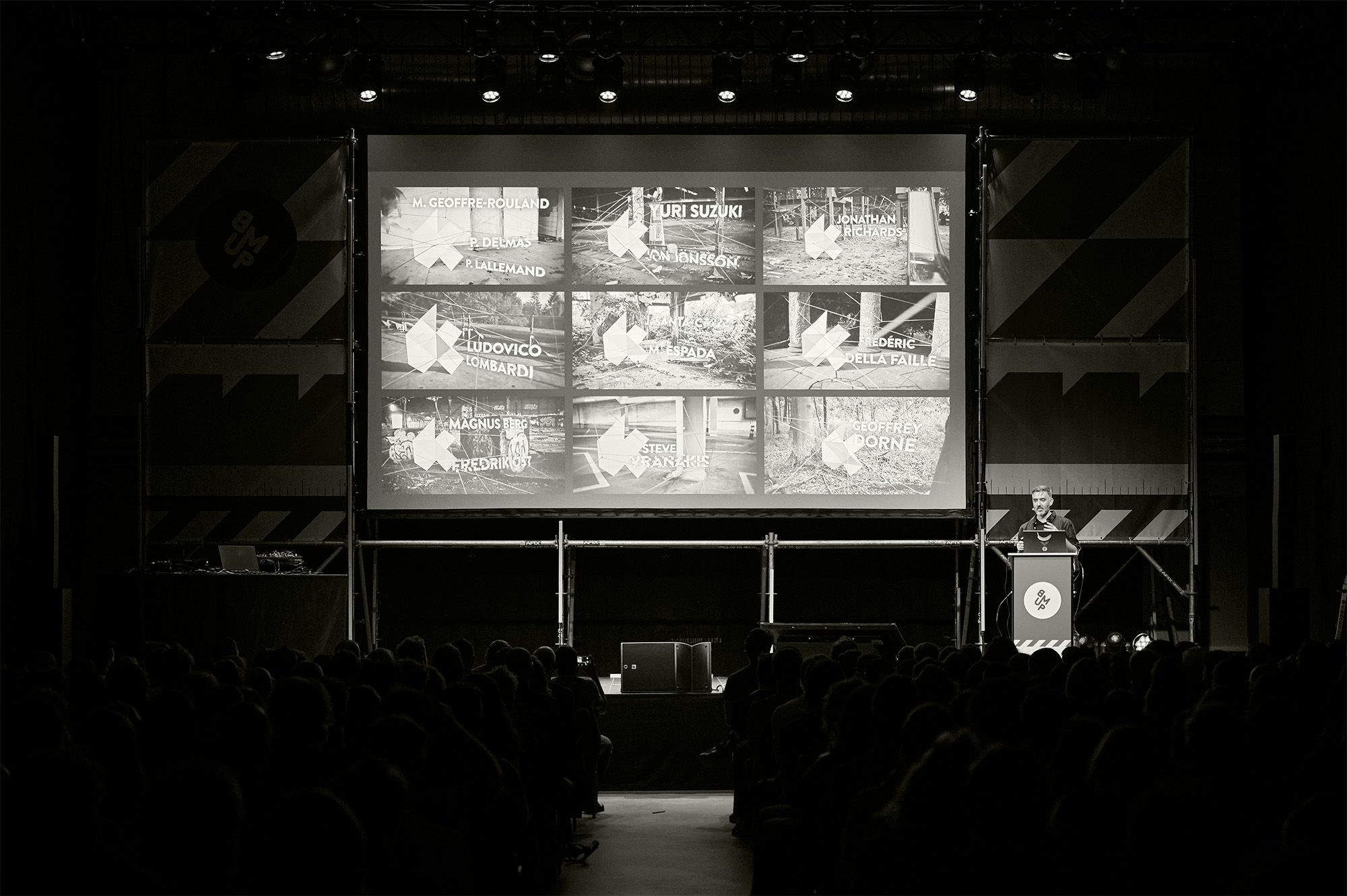 Front view of stage with a grid of images displayed on the projection